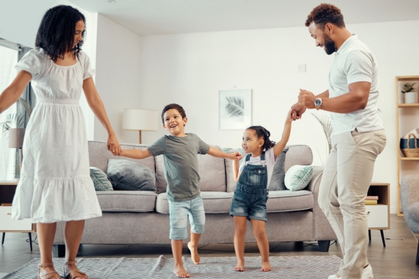 happy family in the living room depicting enjoying new air conditioner unit installed