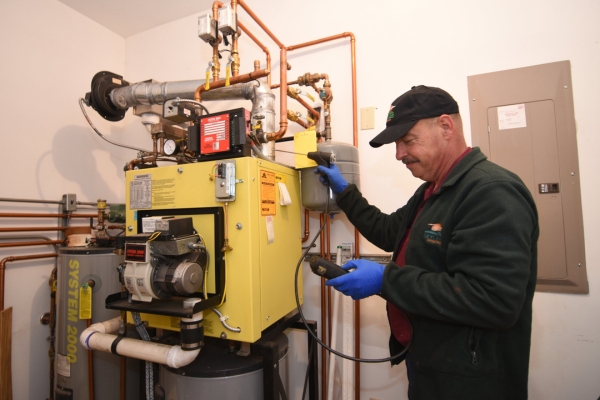 Skylands Energy Service HVAC technician tending to boiler