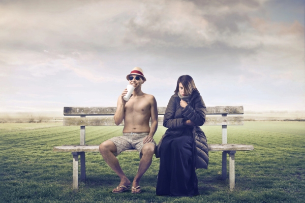 man in summer attire beside woman in winter outfit depicting extreme temperature fluctuations in space