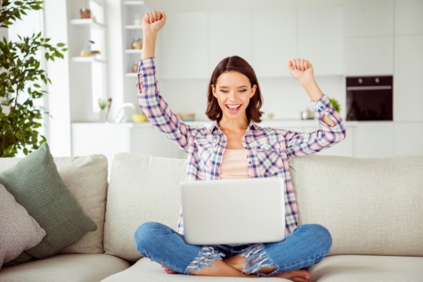 woman feeling happy and productive while staying cool inside the home with AC