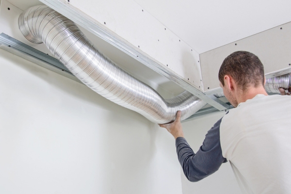 HVAC technician replacing home ductwork due to damage