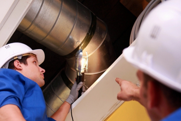 HVAC technicians inspecting ductwork