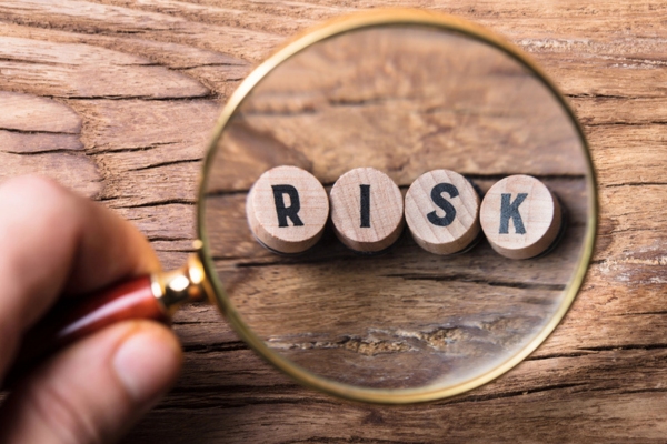 risk spelled using round wooden blocks magnified depicting risks of old air conditioner