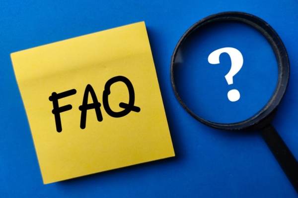 FAQ on yellow sticky note beside magnifying glass and question mark depicting Oil-Fired Hydronic Heating