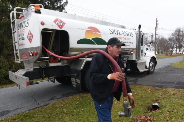 Skylands Energy Service oil delivery person in front of oil truck