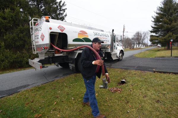 Skylands Energy Service oil delivery person in front of oil truck