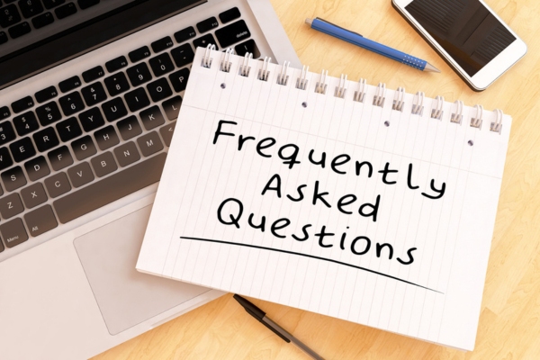 frequently asked questions written on notebook depicting FAQs