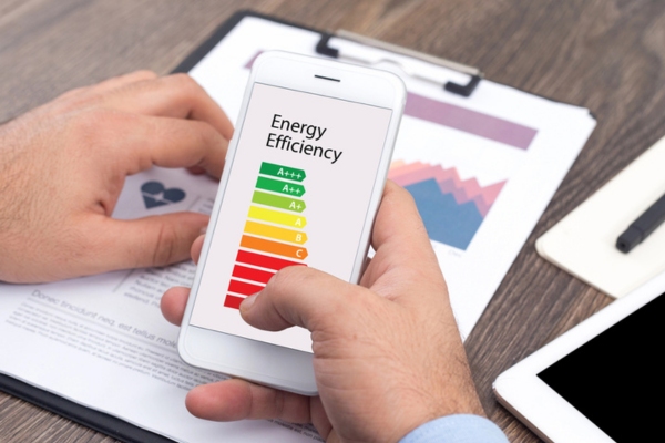 man checking phone for energy efficiency levels depicting furnace efficiency