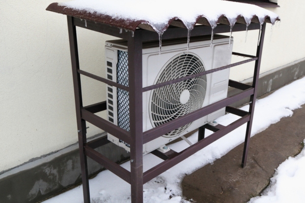 residential heat pump with cover in winter