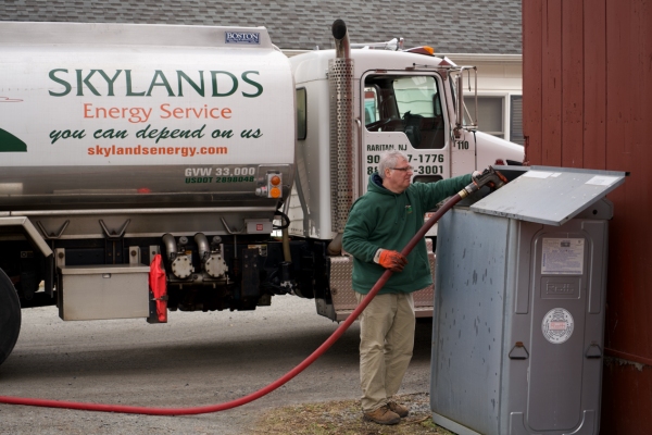 Skylands Energy Service oil delivery person in front of oil truck