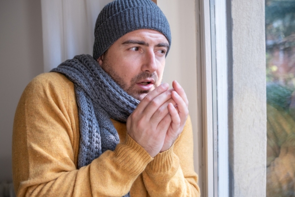 man feeling cold due to furnace not working