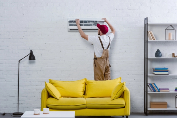 HVAC technician installing supplemental ductless heating system