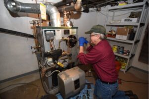 Skylands Energy Service Professional HVAC technician servicing a boiler